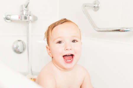 Cute toddler boy taking a bathの写真素材