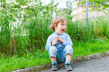 Outdoor portrait of a cute toddler boy on a nice summer dayの写真素材