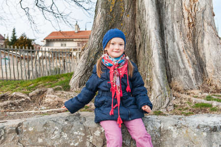 Cute little girl having fun outdoorの写真素材