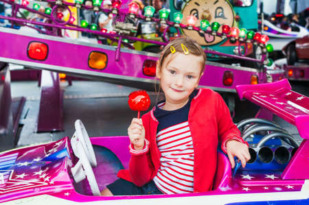 Little girl having fun on carouselの写真素材