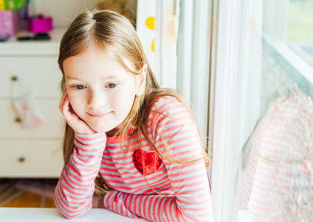 Portrait of adorable little girl in her roomの写真素材