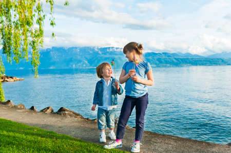 Adorable children playing together on a nice sunny dayの写真素材