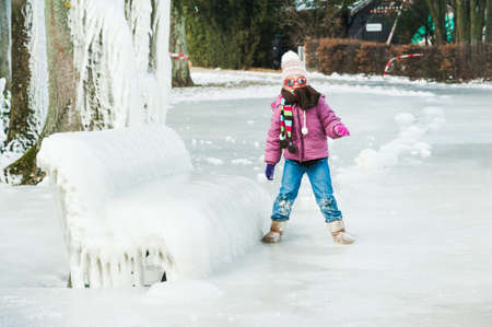 Cute little girl having fun outdoors on a nice winter dayの写真素材