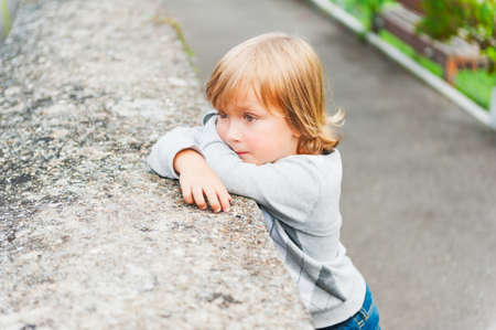 Outdoor portrait of a cute toddler boyの写真素材