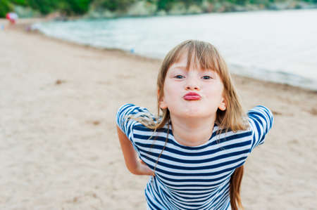 Cute little girl having fun on a beach at summer vacationの写真素材