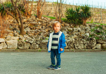 Outdoor portrait of a cute toddler boy on sunset, outdoorsの写真素材
