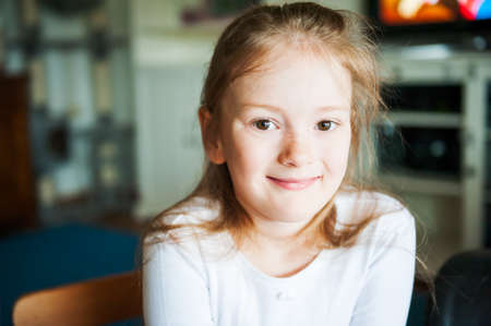 Indoor portrait of a cute little girl in early morningの写真素材