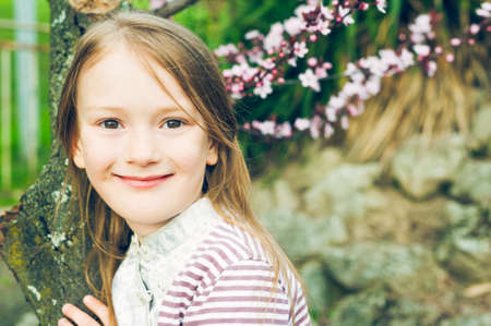Outdoor portrait of a cute little girl, on a nice spring dayの写真素材