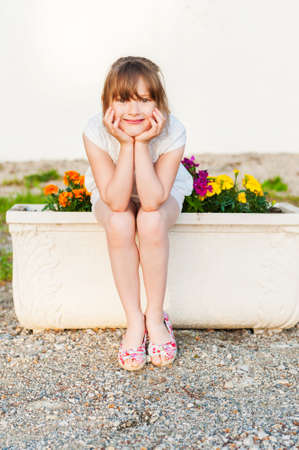 Outdoor portrait of a cute little girl on a nice summer eveningの写真素材