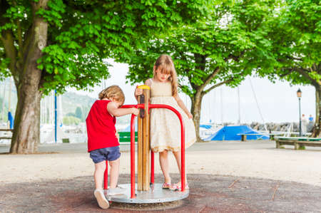 Adorable children playing on playgroundの写真素材