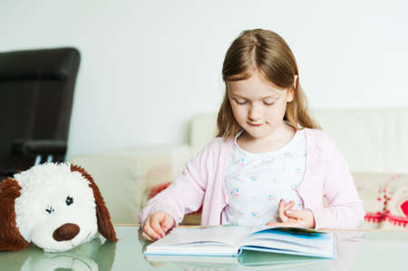 Portrait of a cute little girl indoorsの写真素材