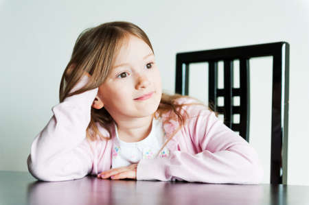 Portrait of a cute little girl indoorsの写真素材