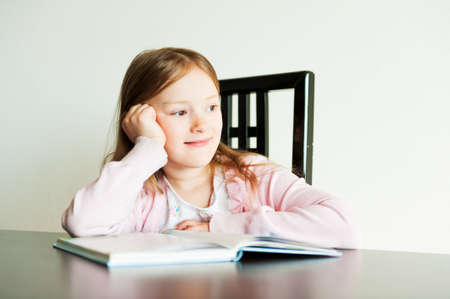 Portrait of a cute little girl indoorsの写真素材
