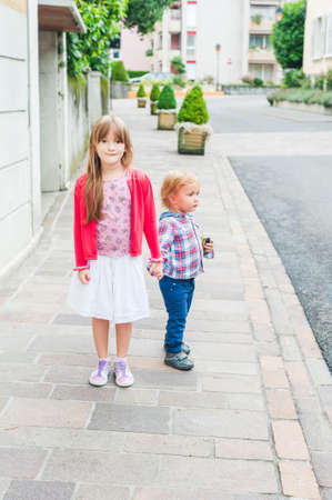 Adorable kids in a city on a nice dayの写真素材