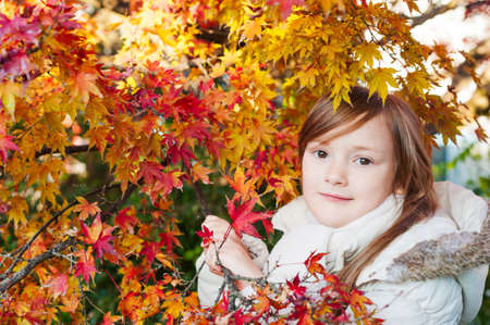Autumn portrait of a beautiful little girlの写真素材