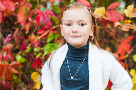 Autumn portrait of a beautiful little girlの写真素材