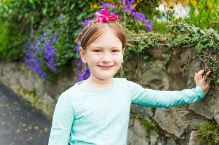 Outdoor portrait of a cute little girl on a nice sunny spring dayの写真素材