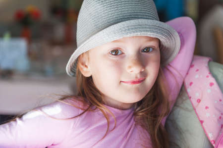 Close up portrait of a cute little girl in a hatの写真素材