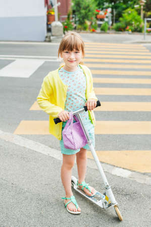 Pretty little girl is going to cross the road aloneの写真素材
