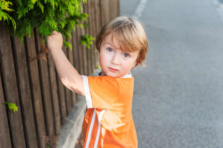 Adorable little boy playing in a neighborhoodの写真素材