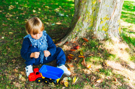 Outdoor portrait of a cute toddler boyの写真素材