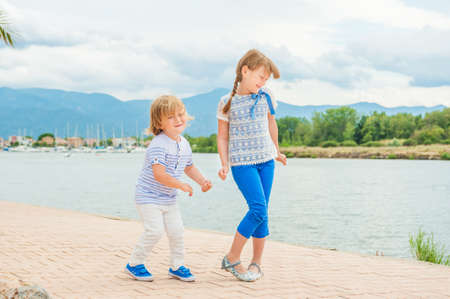 Adorable kids having fun outdoors on a nice sunny summer dayの写真素材