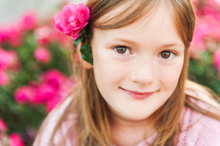 Close up portrait of a cute little girl resting outdoors on a nice sunny eveningの写真素材