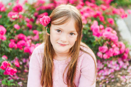Close up portrait of a cute little girl resting outdoors on a nice sunny eveningの写真素材