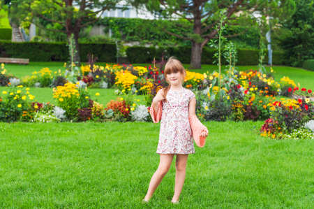 Outdoor portrait of a cute little girl in a park on a nice summer dayの写真素材