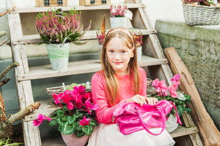 Fashion portrait of adorable little girl on a street in a cityの写真素材