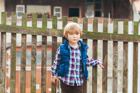 Outdoor portrait of a cute toodler boy resting in a countrysideの写真素材