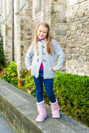 Outdoor portrait of a cute little girl in a city on a nice dayの写真素材
