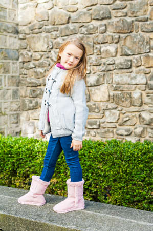 Outdoor portrait of a cute little girl in a city on a nice dayの写真素材