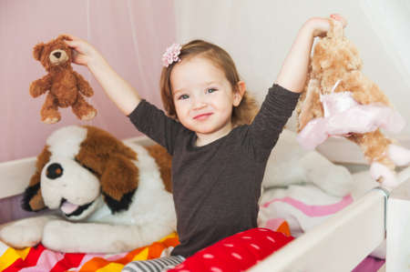 Interior portrait of a cute toddler girl in her roomの写真素材