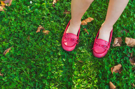 Close up of red moccasins on child\'s feetの写真素材