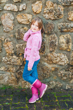Outdoor portrait of adorable little girl wearing pink pulloverの写真素材
