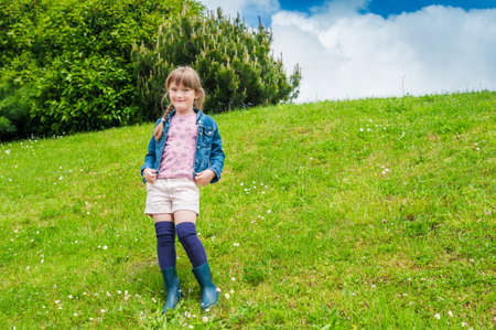 Cute little girl having fun outdoors on a nice summer dayの写真素材