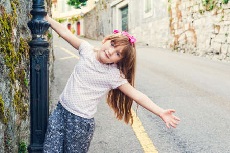 Adorable little girl playing outdoors on a nice summer dayの写真素材