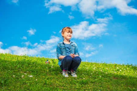 Summer portrait of a cute little girl playing outdoorsの写真素材