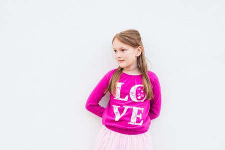 Portrait of a pretty little girl wearing bright pink tshirtの写真素材