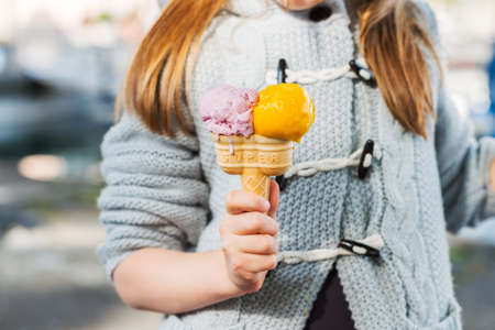 Double ice cream in child's hand