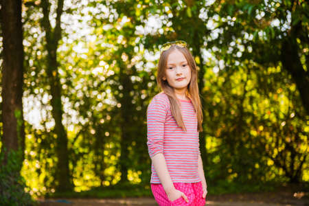 Portrait of a cute little girl of 7 years old in the parkの写真素材