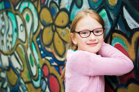 Outdoor portrait of a cute little girl in glassesの写真素材