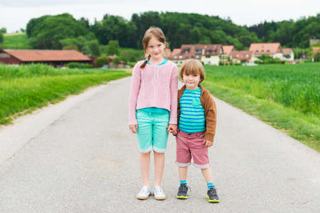 Two cute kids playing in a countrysideの写真素材