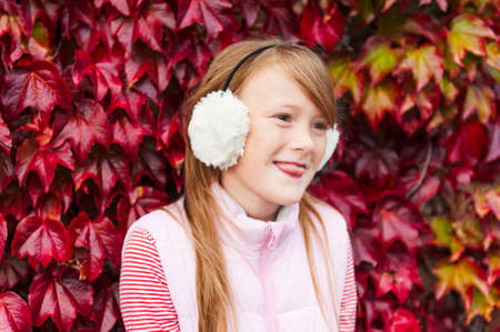 Autumn portrait of a cute little girl wearing pink clothesの写真素材