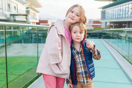 Outdoor portrait of two adorable kids in a cityの写真素材
