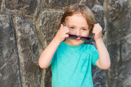 Fashion little boy wearing trendy sunglassesの写真素材