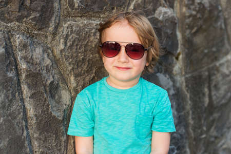 Fashion little boy wearing trendy sunglassesの写真素材