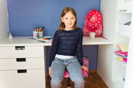 Interior portrait of a cute little girl in her roomの写真素材