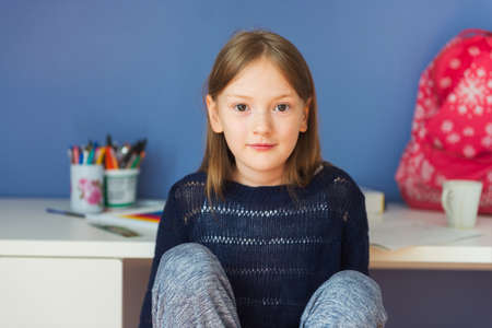 Interior portrait of a cute little girl in her roomの写真素材
